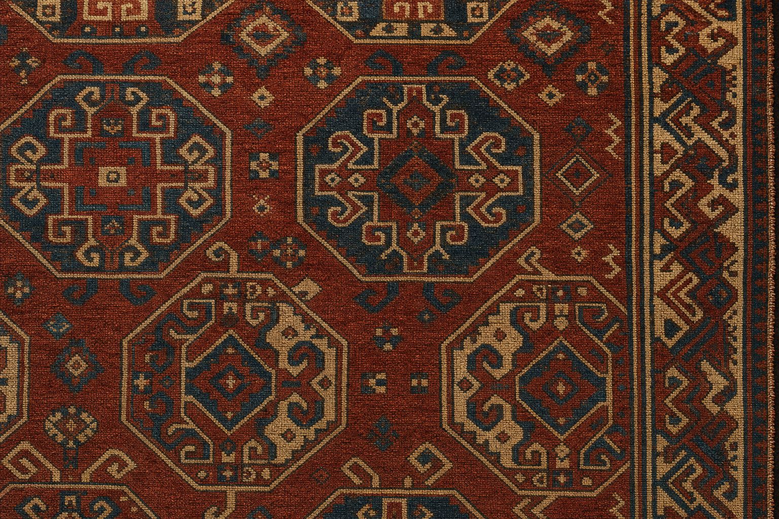Detail of a hand-knotted wool carpet with octagonal medallions in madder red, indigo and ivory